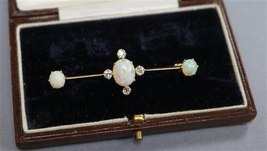 An early 20th century yellow metal, white opal and diamond set bar brooch, 50mm.